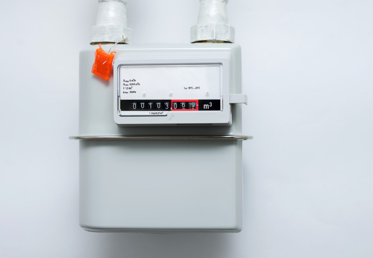 A Gas Meter On The White Wall. Counter For Distribution Natural Gas.