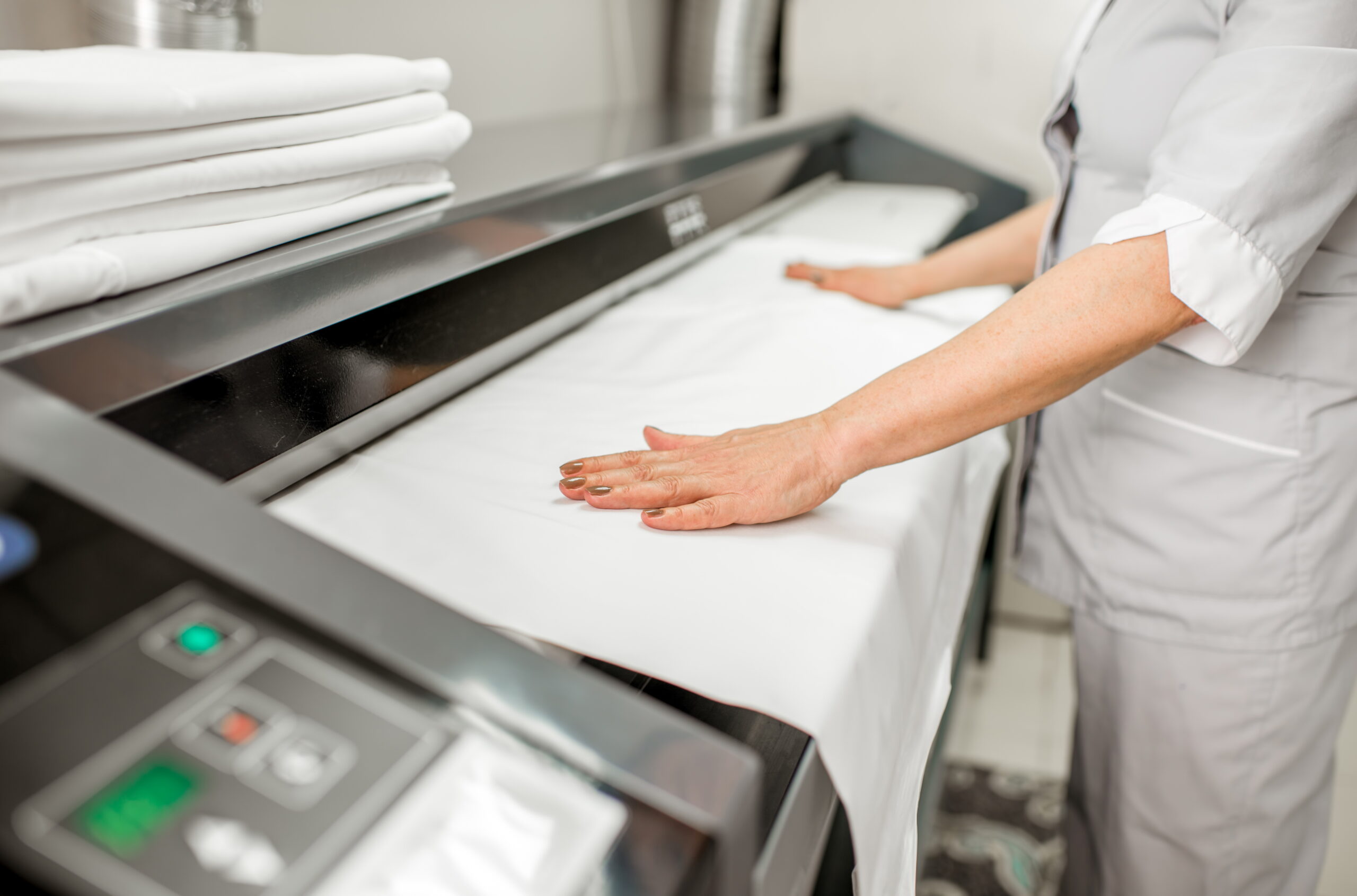 Ironing Bedclothes With Professional Ironing Machine In The Laundry